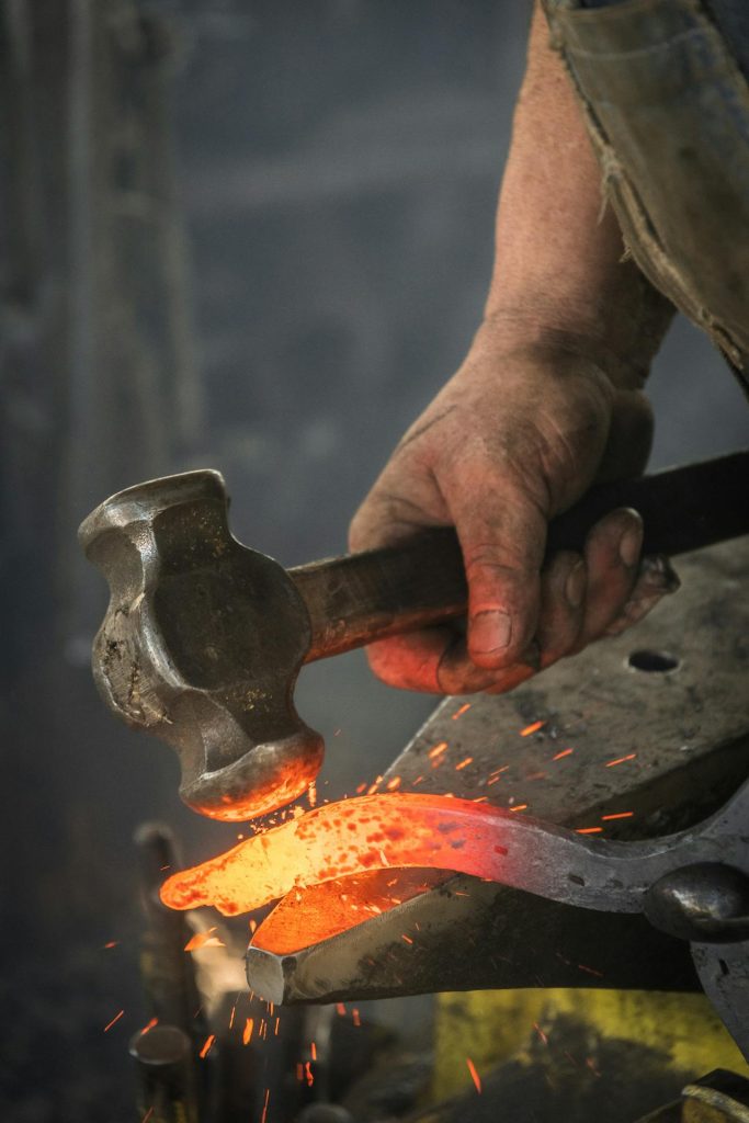 A blacksmith striking steel